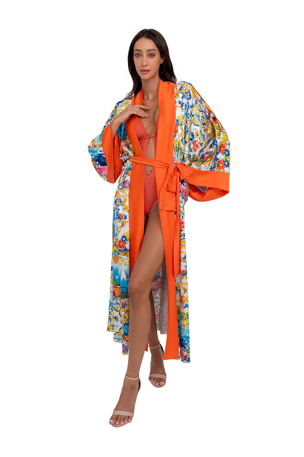 Woman wearing the CAPRI Long Robe in vibrant colors, showcasing a relaxed fit and belted waist, perfect for exclusive resort wear.